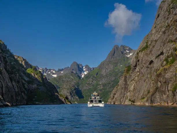 Photo of The Trollfjord or Trollfjorden, Hadsel, Lofoten Islands, Nordland, Norway. The  fjord is only accessible by boat and it is famous for its narrow entrance and steep-sided mountains surrounding it