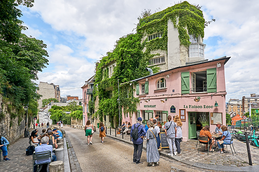 Paris, France - July 13, 2023: Crowd in front of the small restaurant Maison Rose in the Montmartre district.