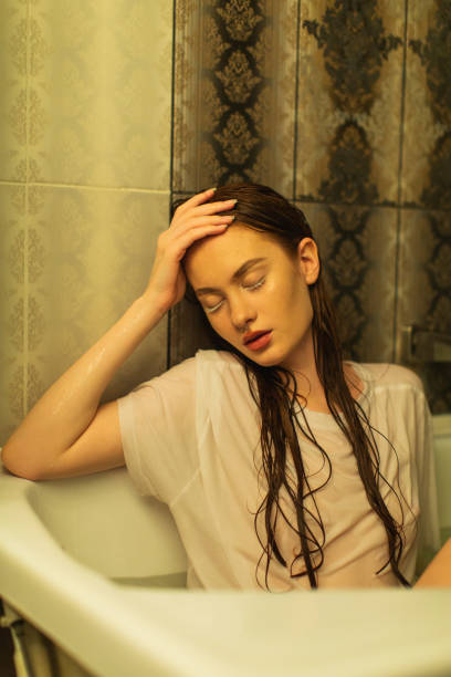 istock Asian redhead woman in shower. Bathroom. 1684266559