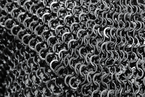 Chain mail close up photo with selective focus. Medieval knight torso armor made of linked steel rings