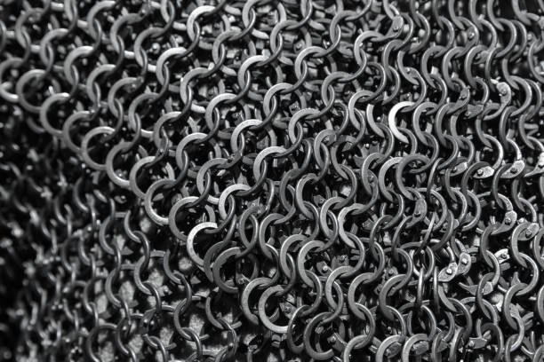 Chain mail close up photo with selective focus Chain mail close up photo with selective focus. Medieval knight torso armor made of linked steel rings chain mail stock pictures, royalty-free photos & images