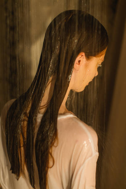 istock Asian redhead woman in shower. Bathroom. 1684286554