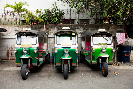Bangkok, Thailand; 1st January 2023: Three tuk tuks in a row on a city street..