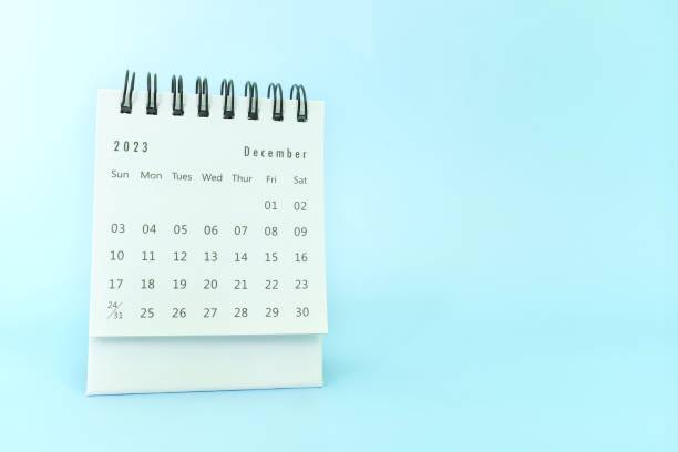 istock Selective focus of December 2023 desk calendar on blue background with copy space. 1684316075