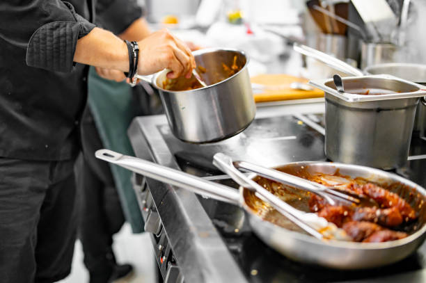 chef cook hand cooking cabbage food at the restaurant kitchen - bigos imagens e fotografias de stock