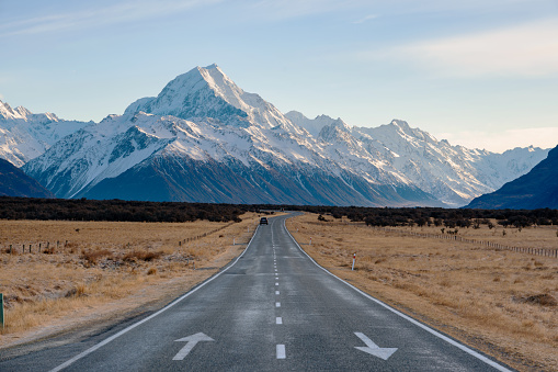 Early morning light shines down on the road that runs through the Mt Cook National Park, on New Zealand's South Island