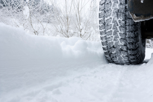 Winter Tyre on snow covered road.