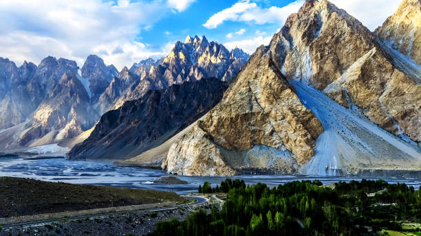 Fascinating view of the Passu cones and glacier in the karakoram mountains range Tupopdan 6,106 metres also known as 'Passu Cones' or 'Passu Cathedral', lies to the north of the Gulmit village in Gojal Valley alongside the karakoram highway on the way to China Pakistan border karakoram range stock pictures, royalty-free photos & images