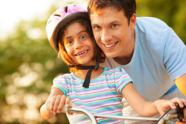 istock Father Teaching Child to ride a bicycle. 168439944