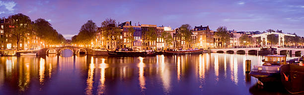 istock Illuminated Amsterdam Canal Bridges at Night Holland 168439976