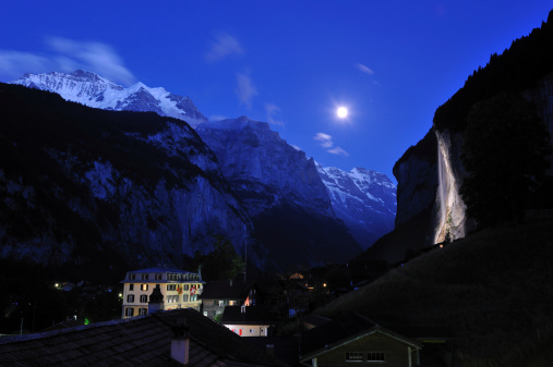 Illuminated waterfalls with mountain peaks under moon light, Lauterbrunnen, Switzerland
