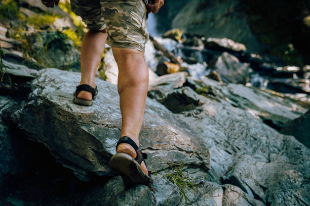 istock Mens foot steps in sandals in the mountains 1684404441