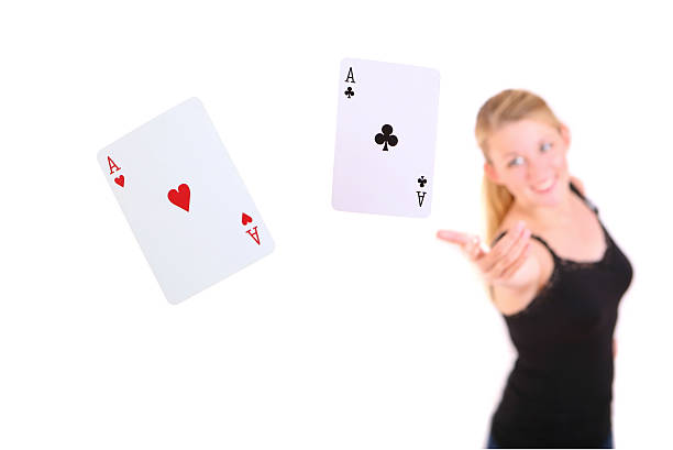 young woman holding in hand poker card with combination of Full House. in focus hand and poker card.