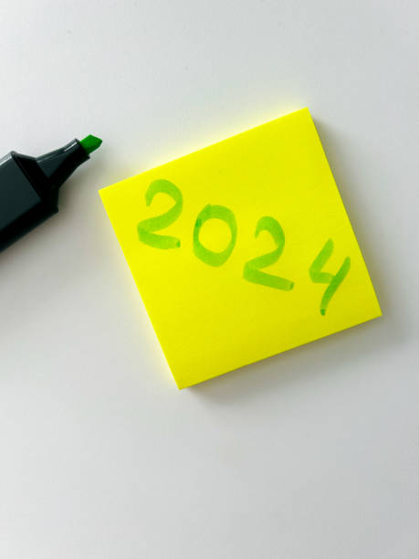 istock New Year 2024 is written on yellow note paper on a light background. Business concept. Plans for the new year. 1684459135