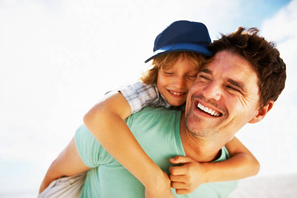 istock Boy enjoys a piggy back ride on father 168446909