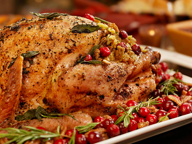 Turkey Dinner Turkey Dinner, with a Cranberry, Sage Dressing, Candied Pecans with Cranberrys and Rosemary  -Photographed on Hasselblad H3D2-39mb Camera sauces table turkey christmas stock pictures, royalty-free photos & images