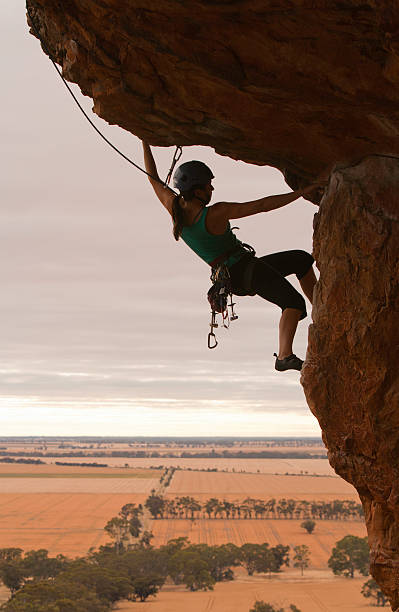 istock Woman rockclimbing silhouette 168447265