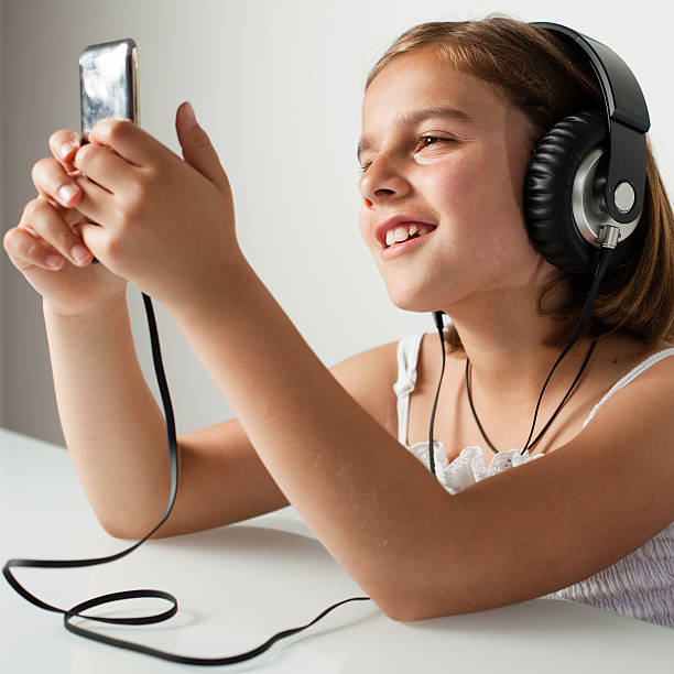 Little Girl with Big Headphones Smiling stock photo