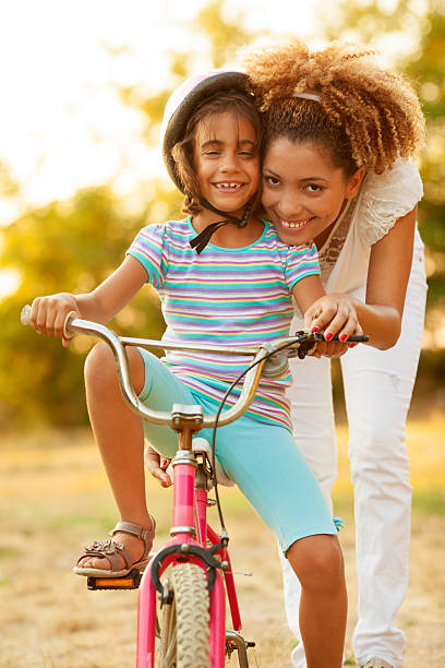 istock Mother Teaching Child to ride a bicycle. 168447934