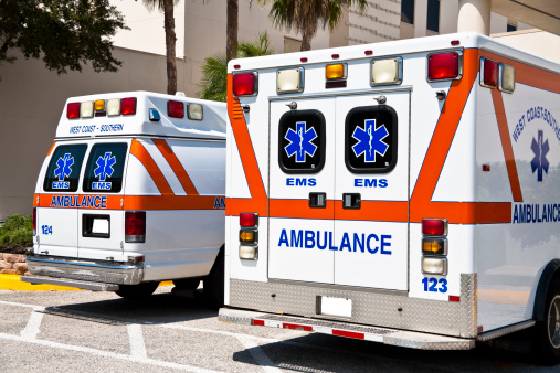 Ambulances. Emergency Medical Vehicles - EMS - Emergency Medical Services vehicles at a hospital with Emergency Ambulance Entrance. Urgent care.