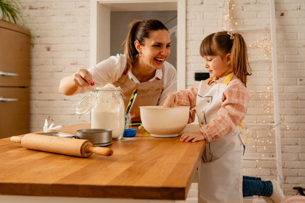 istock Mother and child having fun in the kitchen preparing meal together 1684486201