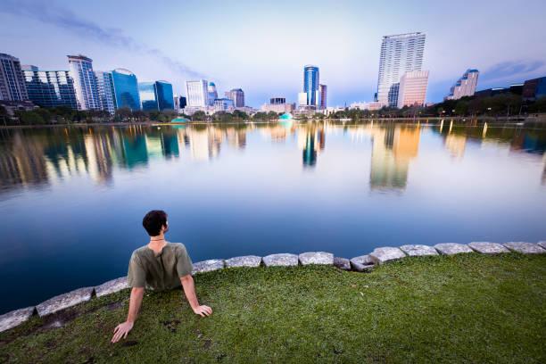 Man enjoying the view in Orlando Man staring at the cityscape of Orlando, Florida, USA. lake eola stock pictures, royalty-free photos & images