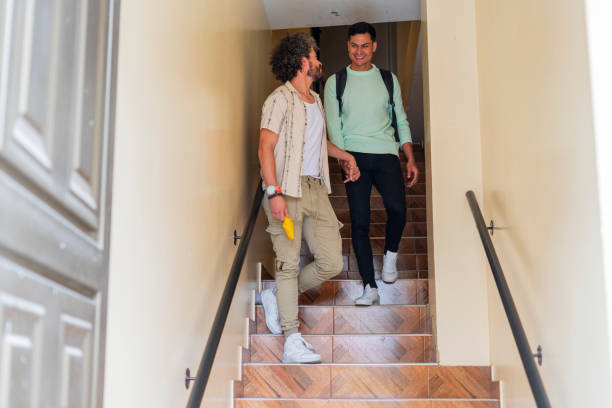 istock A gay couple chats while walking down the stairs and enjoying a conversation 1684514276