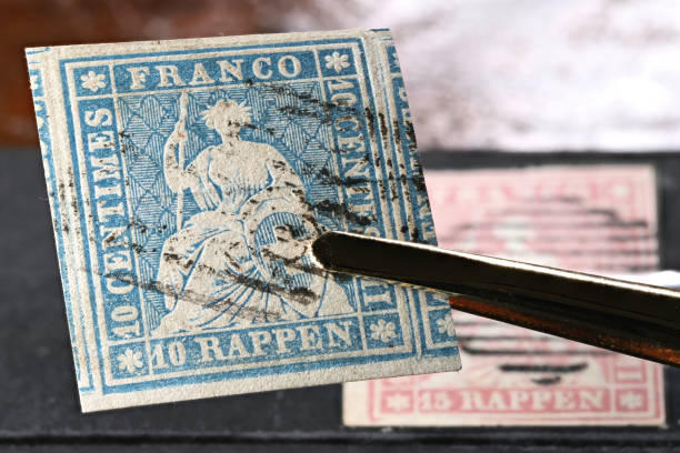 istock Swiss 10 Rappen Strubel stamp held by tweezers. 1684522857