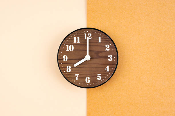 istock A Wooden clock placed in middle of brown colcor background. 1684532156