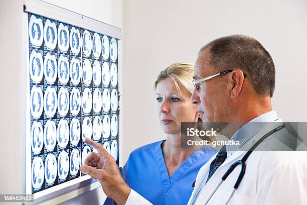 Doctor And Nurse Consulting On Xray Stock Photo - Download Image Now - Adult, Adults Only, Analyzing