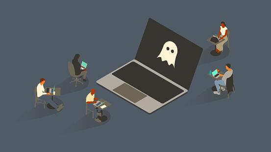 Five people surround an oversized laptop with a ghost icon on-screen. Everyone uses laptop computers themselves. Isometric vector illustration leverages a limited color palette on a 16x9 artboard. Icon created from scratch by the illustrator.