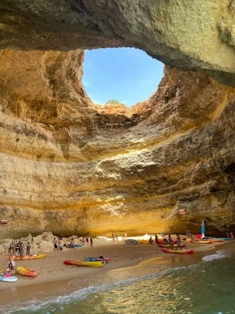 Benagil cave, also known as Benagil Algar, is a huge sea cave located on the southern coast of Portugal, in the Algarve region, next to Benagil beach between Portimão, Albufeira and Lagoa. It is possibly one of the most famous places in Portugal, attracting lots of visitors and it is characterized by two entrances facing the sea and a giant hole on its ceiling. Inside the cave there is also a small beach where you can walk around, dip your feet in the sea and enjoy this stunning sea cave. You can only reach Benagil Cave by the sea.