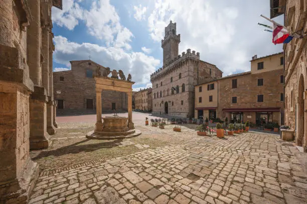 Piazza Grande, the well, and Palazzo Comunale, town hall of Montepulciano. Nobody in the square, Val di Chiana or Valdichiana territory, Tuscany region, Italy
