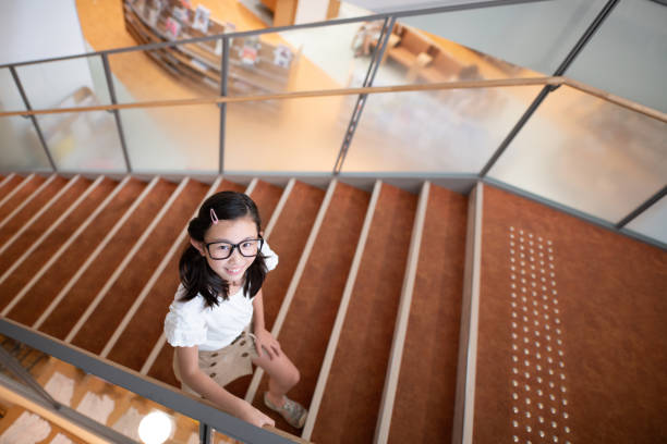 Young woman is walking downstairs in office building