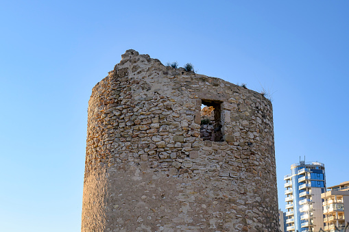 Ruins of a medieval building in Calpe boulevard or promenade, Spain
