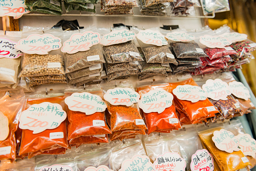 In Tokyo, Japan bags with spices are priced and displayed for sale on the wall of a booth at the Tsukiji fish market.