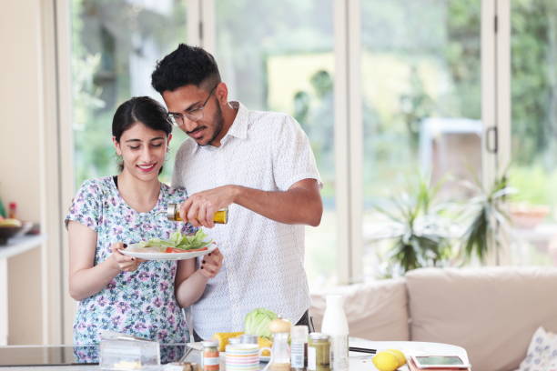istock Young couple dress salad together 1684642907