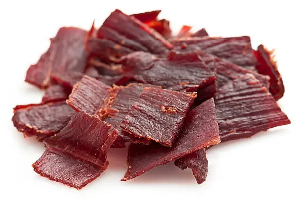 Pile of beef jerky on white background