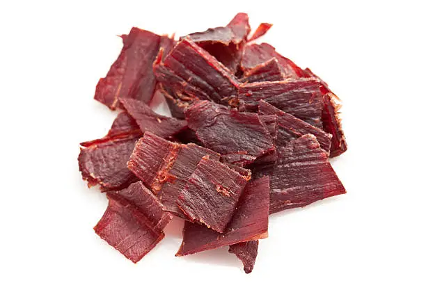Pile of beef jerky on white background