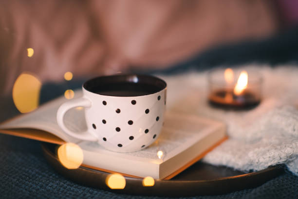 istock Cup of tea on book in bed 1684654651
