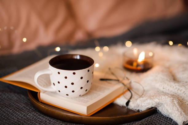 istock Cup of tea on book in bed 1684654666