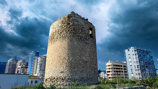 Ruins of a medieval building in Calpe boulevard or promenade, Spain