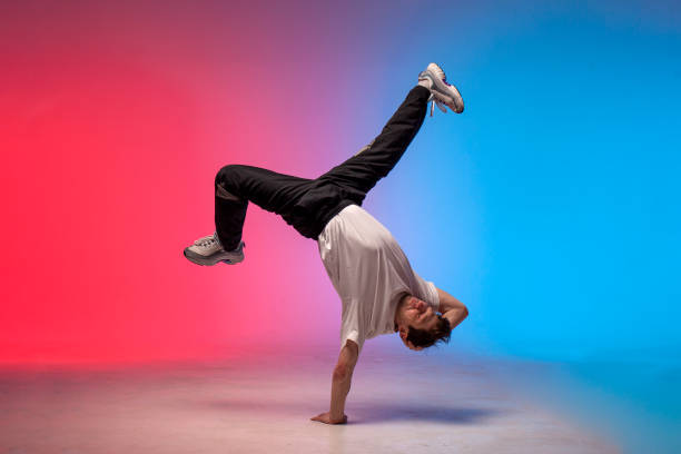 istock dancer doing acrobatic trick and dancing breakdance in neon red and blue lighting 1684671585