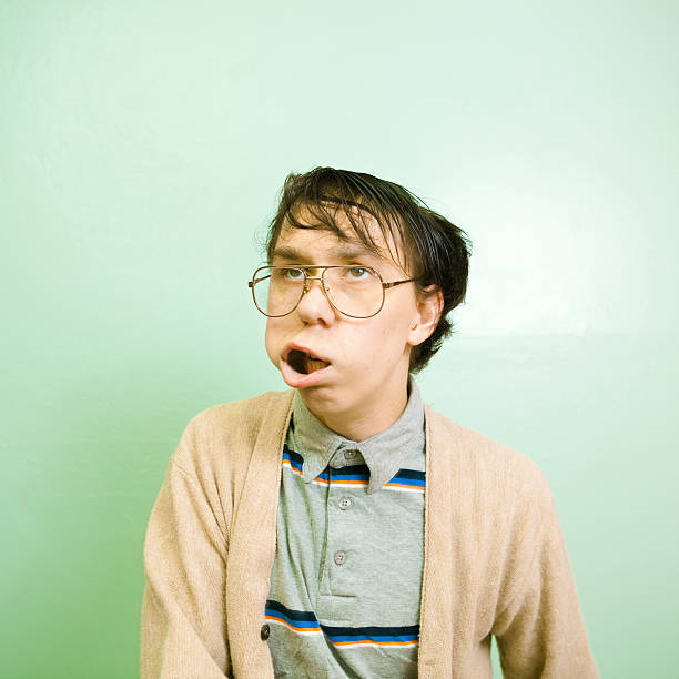 Nerdy dude with wild facial expression An extremely nerdy guy makes a wild facial expression. ugly face stock pictures, royalty-free photos & images