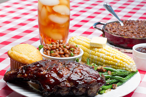 Grilled pork ribs with spices and vegetables on a wooden background