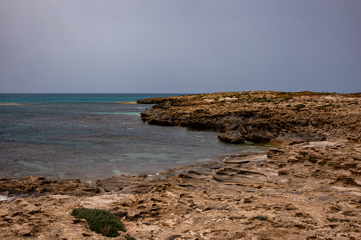 Comino Island view of a bay with turqouise water , and cliffs - Malta