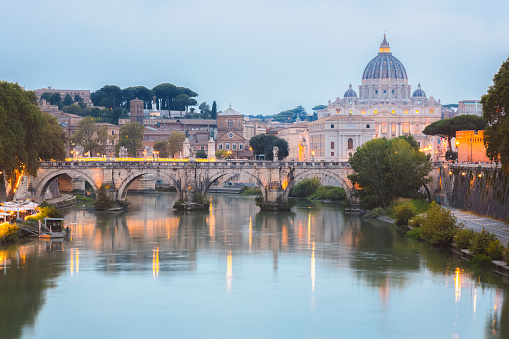 St. Peter's Basilica in Vatican and Tiber river in Rome at sunset