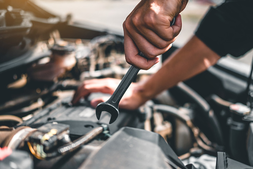 Auto mechanic working in garage Technician Hands of car mechanic working in auto repair Service and Maintenance car check.