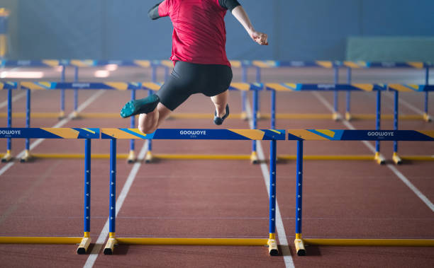 istock Male Runner Training And Jumping Through Hurdles 1684712225