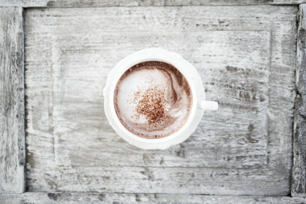 istock Cocoa in white cup on grunge wooden table flat lay 1684713269